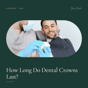 Dentist showing smiling male patient a dental crown model - how long do dental crowns last, Barton Dental