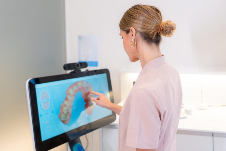 Dentist reviewing a digital image of teeth on a screen