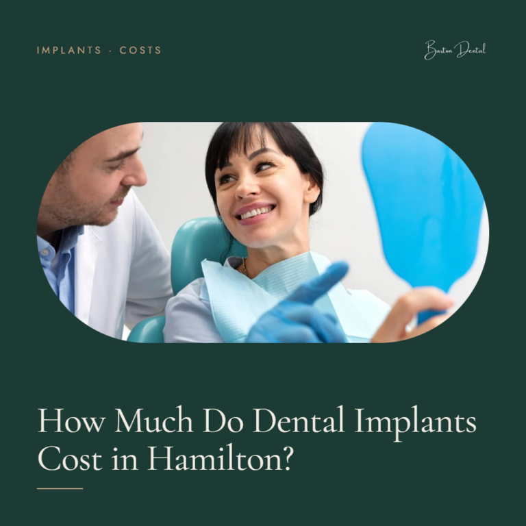 Dentist showing smiling female patient a hand mirror - dental implants cost guide for Hamilton, Barton Dental